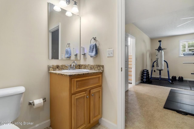 1421 W Elm Rd, Radcliff, KY 40160 - bathroom featuring toilet, baseboards, and vanity