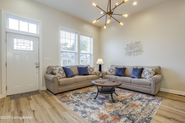 421 Marret Ave, Louisville, KY 40208 - living room featuring light wood-type flooring, a chandelier, and baseboards