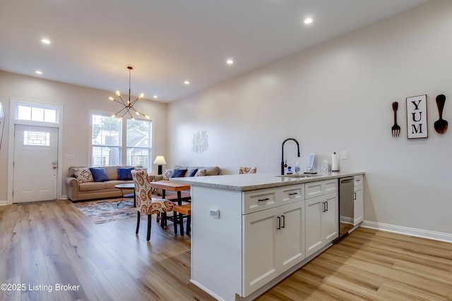 421 Marret Ave, Louisville, KY 40208 - kitchen featuring a sink, light wood-type flooring, white cabinets, a chandelier, and recessed lighting