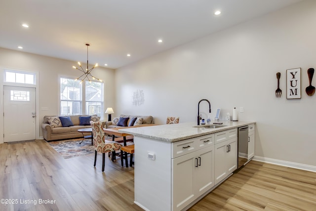 421 Marret Ave, Louisville, KY 40208 - kitchen featuring a sink, light wood-style flooring, a chandelier, stainless steel dishwasher, and recessed lighting