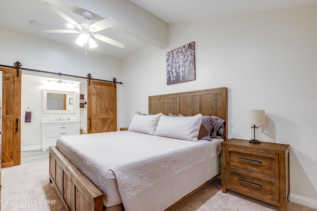 421 Marret Ave, Louisville, KY 40208 - bedroom with a barn door, light carpet, ensuite bathroom, and baseboards