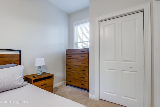 421 Marret Ave, Louisville, KY 40208 - bedroom featuring light carpet, baseboards, and a closet