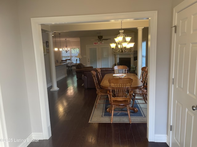 6008 Cottage Ln, Crestwood, KY 40014 - dining room featuring a chandelier, dark wood-type flooring, ceiling fan, baseboards, and ornate columns