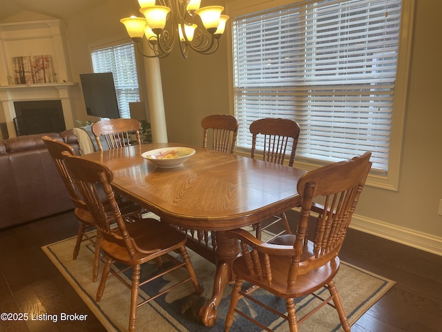 6008 Cottage Ln, Crestwood, KY 40014 - dining space featuring a chandelier, wood finished floors, baseboards, and a fireplace