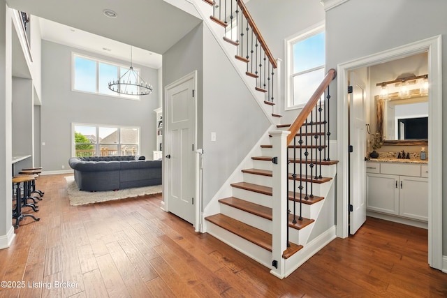 7811 Ingram Way, Crestwood, KY 40014 - stairs with a towering ceiling, hardwood / wood-style floors, a chandelier, and baseboards