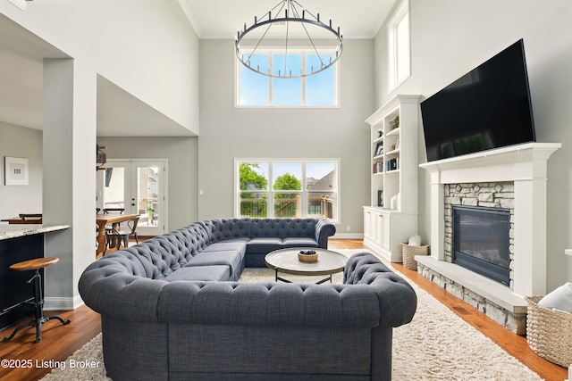 7811 Ingram Way, Crestwood, KY 40014 - living room with wood finished floors, a towering ceiling, a stone fireplace, and baseboards