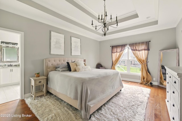 7811 Ingram Way, Crestwood, KY 40014 - bedroom with a raised ceiling, a chandelier, light wood finished floors, crown molding, and a sink