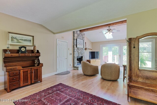 6311 Fible Ln, Crestwood, KY 40014 - living area with vaulted ceiling, light wood-type flooring, a stone fireplace, ceiling fan, and baseboards