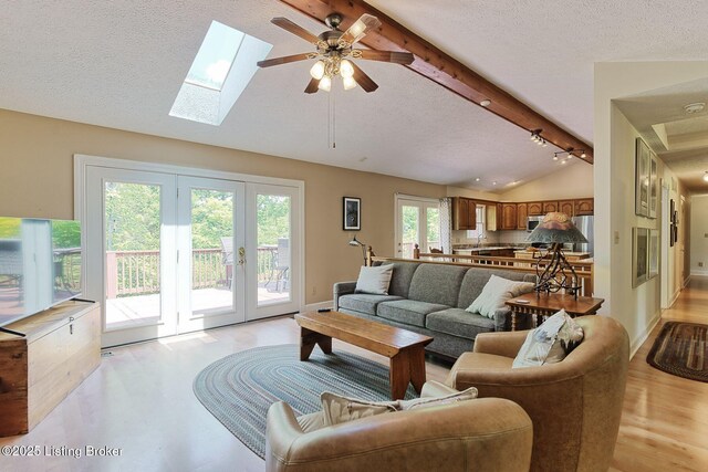 6311 Fible Ln, Crestwood, KY 40014 - living room featuring french doors, a textured ceiling, ceiling fan, a skylight, and light wood-style floors