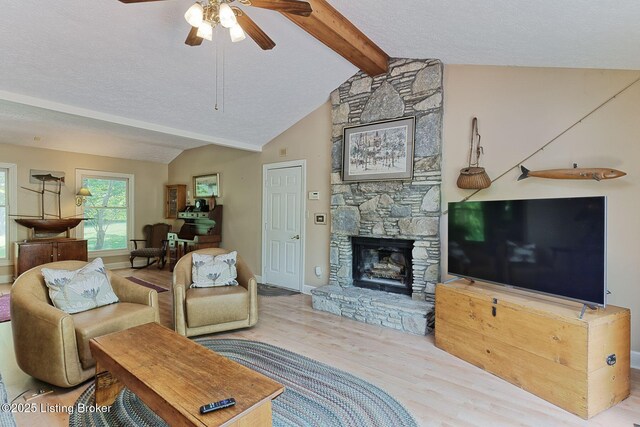 6311 Fible Ln, Crestwood, KY 40014 - living room featuring a ceiling fan, wood finished floors, a textured ceiling, a fireplace, and baseboards