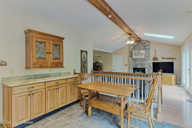 6311 Fible Ln, Crestwood, KY 40014 - dining space with ceiling fan, a skylight, and a stone fireplace