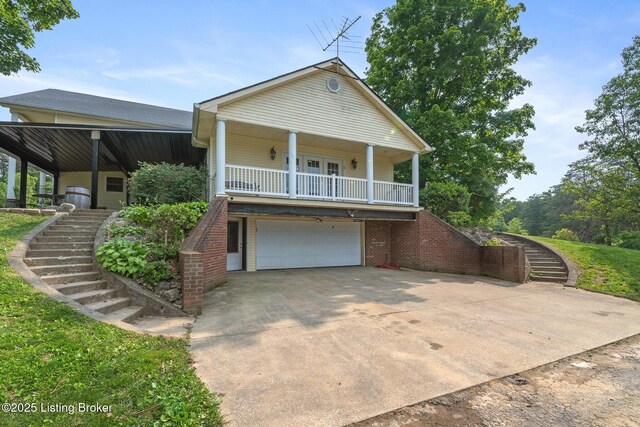 622 Hillcreek Dr, Elizabethtown, KY 42701 - view of front of home featuring stairs, a garage, covered porch, driveway, and brick siding