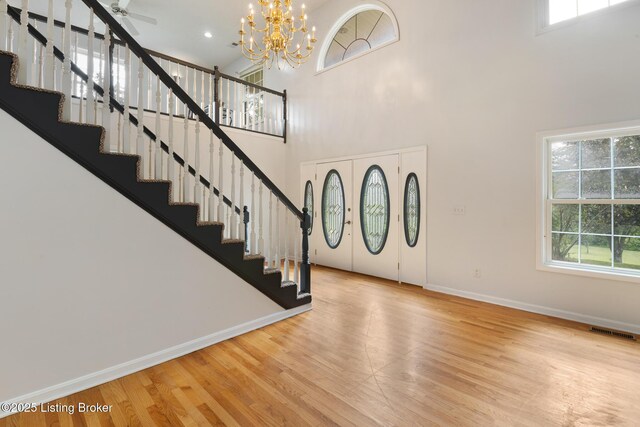 622 Hillcreek Dr, Elizabethtown, KY 42701 - entrance foyer with stairs, baseboards, wood finished floors, a high ceiling, and a chandelier