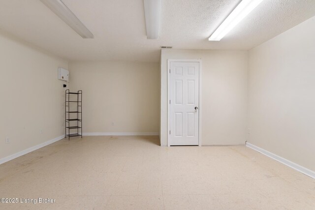 622 Hillcreek Dr, Elizabethtown, KY 42701 - empty room with tile patterned floors, a textured ceiling, and baseboards