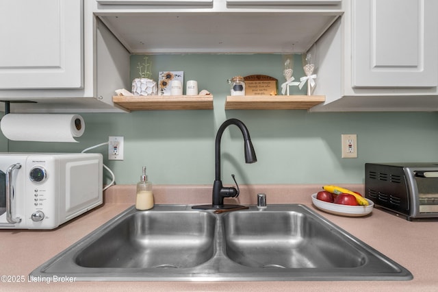 165 Central Blvd Apt 51, Mt Washington, KY 40047 - kitchen view of a sink, white cabinets, and open shelves