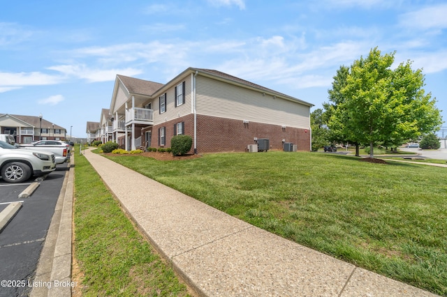 165 Central Blvd Apt 51, Mt Washington, KY 40047 - view of property exterior featuring brick siding, central AC unit, and a yard