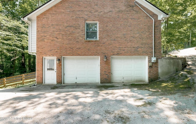 211 Rebel Dr, Pewee Valley, KY 40056 - view of side of home featuring an attached garage and brick siding