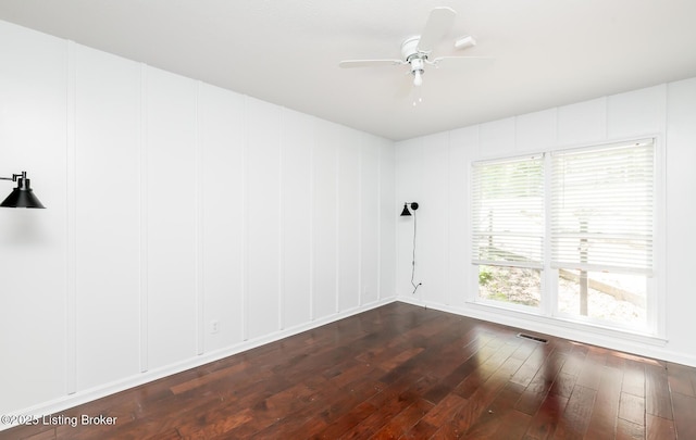 211 Rebel Dr, Pewee Valley, KY 40056 - spare room featuring dark wood finished floors, a ceiling fan, and a decorative wall