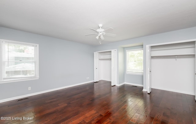211 Rebel Dr, Pewee Valley, KY 40056 - unfurnished bedroom with multiple closets, baseboards, dark wood-style floors, and a ceiling fan
