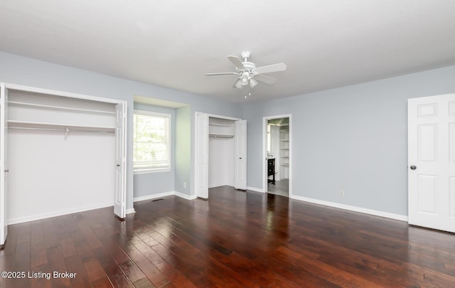 211 Rebel Dr, Pewee Valley, KY 40056 - unfurnished bedroom featuring two closets, baseboards, hardwood / wood-style floors, and a ceiling fan