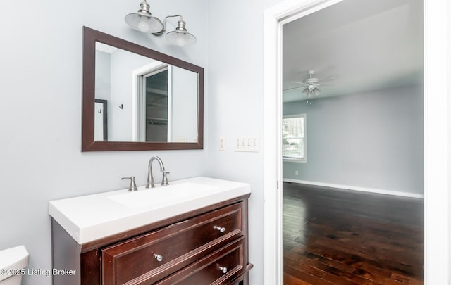 211 Rebel Dr, Pewee Valley, KY 40056 - bathroom featuring vanity, wood-type flooring, a ceiling fan, toilet, and baseboards