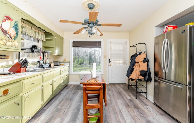 4825 Manslick Rd, Louisville, KY 40216 - kitchen with freestanding refrigerator, green cabinets, light countertops, and ceiling fan