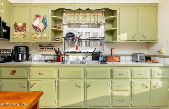 4825 Manslick Rd, Louisville, KY 40216 - kitchen with open shelves, green cabinets, tile countertops, a sink, and range