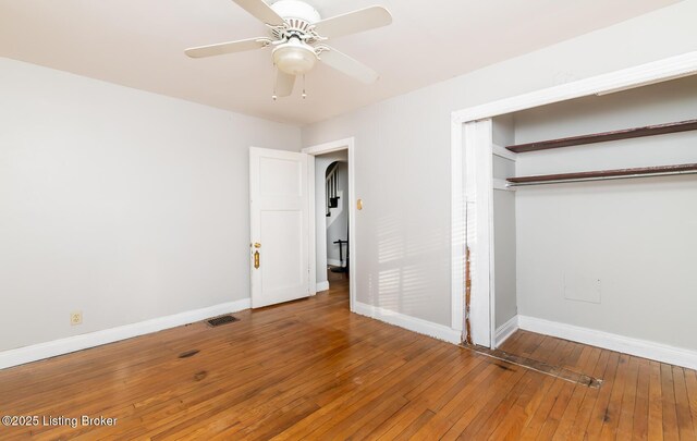 4825 Manslick Rd, Louisville, KY 40216 - unfurnished bedroom featuring baseboards, hardwood / wood-style floors, a closet, and ceiling fan