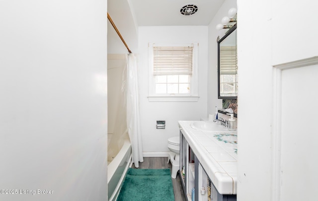 4825 Manslick Rd, Louisville, KY 40216 - full bathroom featuring toilet, vanity, shower / bath combo, wood finished floors, and baseboards
