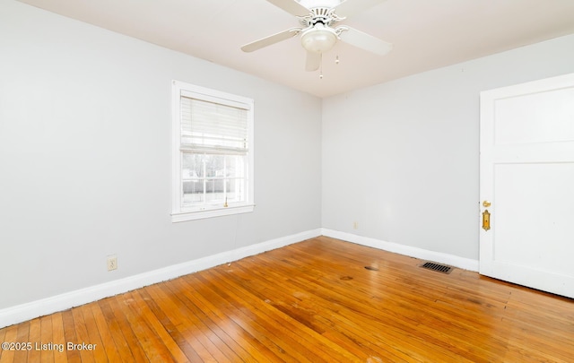4825 Manslick Rd, Louisville, KY 40216 - spare room with baseboards, wood-type flooring, and ceiling fan