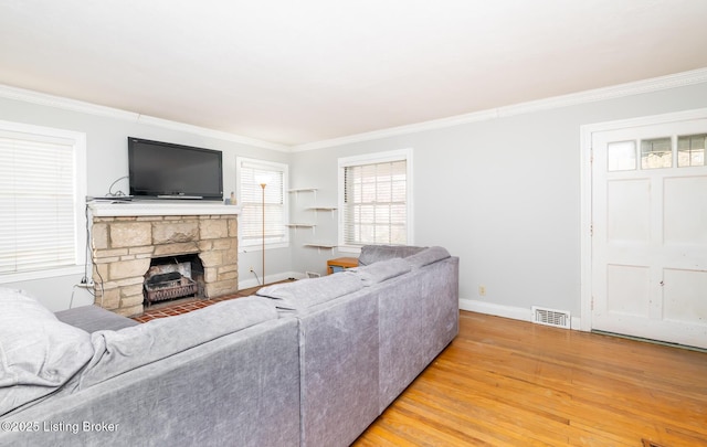 4825 Manslick Rd, Louisville, KY 40216 - living room featuring light wood-type flooring, crown molding, baseboards, and a fireplace