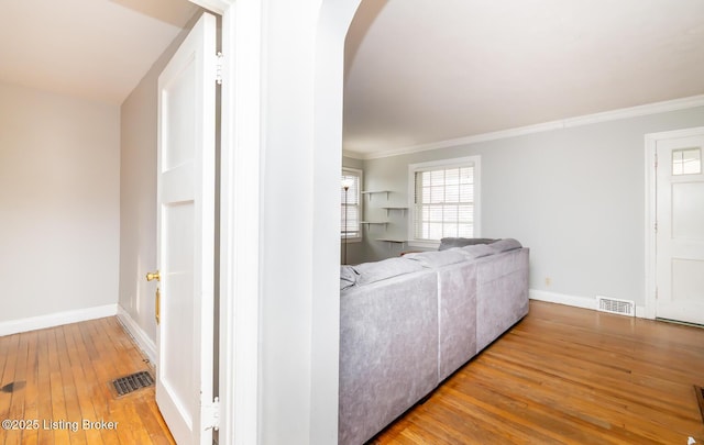 4825 Manslick Rd, Louisville, KY 40216 - living room featuring hardwood / wood-style floors, arched walkways, ornamental molding, and baseboards