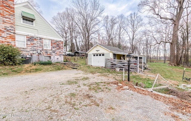 4825 Manslick Rd, Louisville, KY 40216 - view of yard featuring driveway, an outbuilding, and a detached garage
