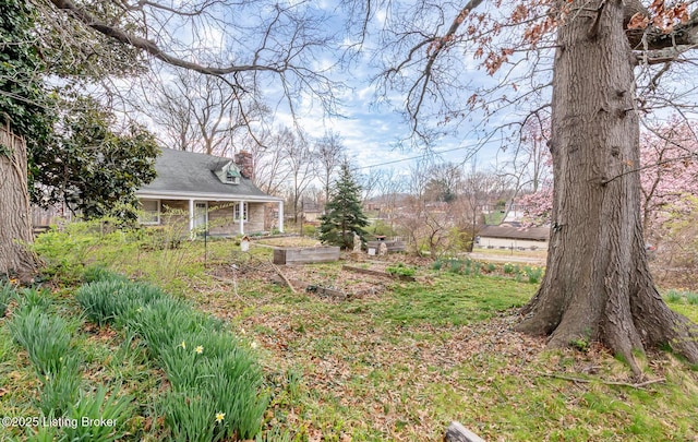 4825 Manslick Rd, Louisville, KY 40216 - view of yard featuring a vegetable garden and a porch