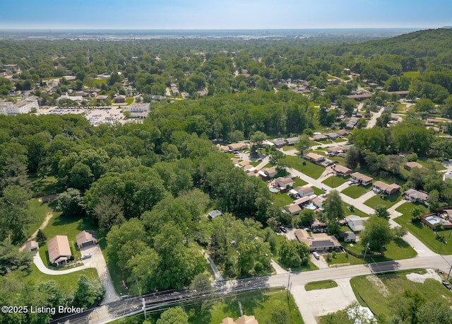 4825 Manslick Rd, Louisville, KY 40216 - aerial view of property and surrounding area featuring a heavily wooded area