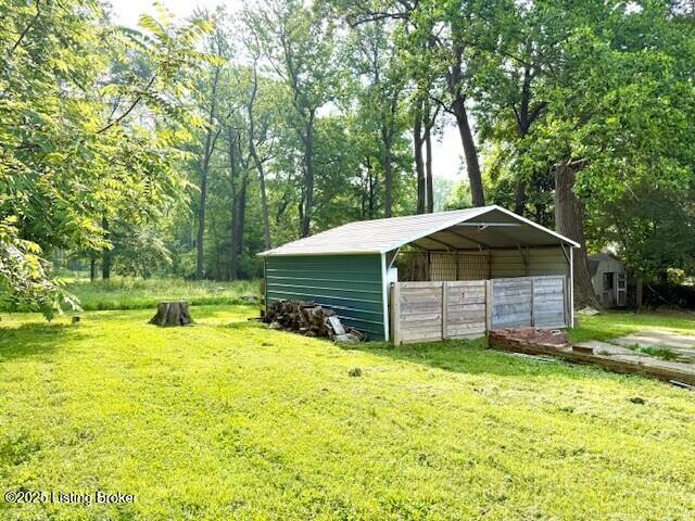 4825 Manslick Rd, Louisville, KY 40216 - view of pole building with a detached carport, a yard, and driveway