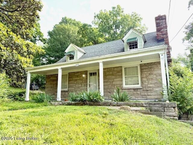 4825 Manslick Rd, Louisville, KY 40216 - cape cod home with stone siding, a chimney, a front lawn, and covered porch