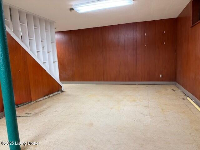 4825 Manslick Rd, Louisville, KY 40216 - finished below grade area with wooden walls, light flooring, and stairway