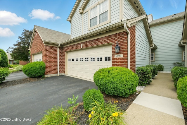 4926 Merton Sq, Louisville, KY 40241 - view of home's exterior with brick siding, driveway, and a garage