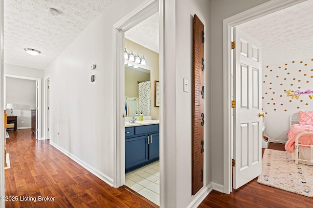5500 Worthington Place Dr, Louisville, KY 40241 - corridor featuring a textured ceiling, wood finished floors, baseboards, and a sink