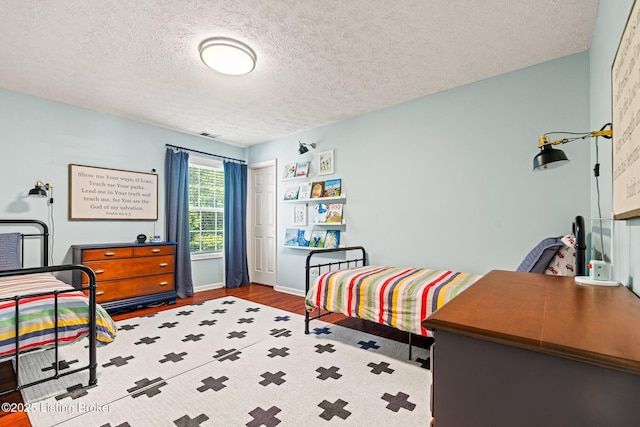 5500 Worthington Place Dr, Louisville, KY 40241 - bedroom featuring wood finished floors, a textured ceiling, baseboards, and a closet