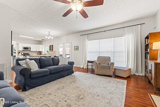 5500 Worthington Place Dr, Louisville, KY 40241 - living area featuring dark wood-style floors, a ceiling fan, a textured ceiling, a chandelier, and baseboards