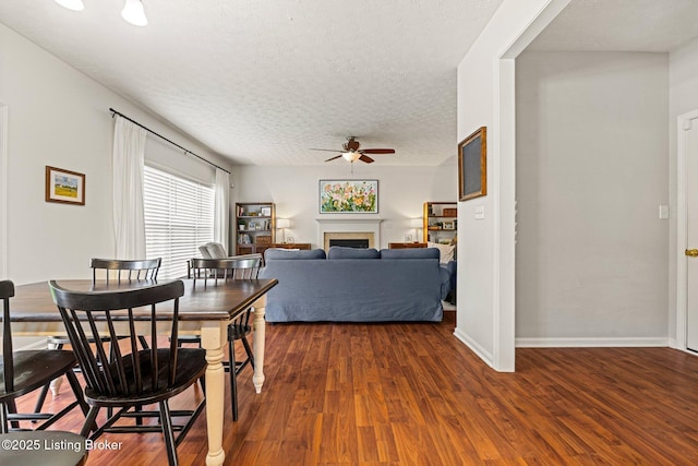 5500 Worthington Place Dr, Louisville, KY 40241 - dining area featuring a ceiling fan, wood finished floors, a fireplace, a textured ceiling, and baseboards