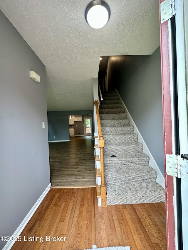 512 Auburn Oaks Dr, Louisville, KY 40214 - stairs with wood finished floors, a textured ceiling, and baseboards