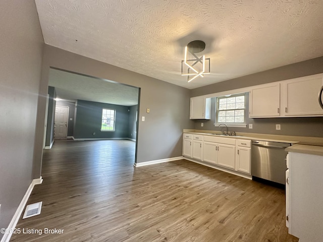 512 Auburn Oaks Dr, Louisville, KY 40214 - kitchen with dishwasher, a sink, wood finished floors, white cabinets, and a textured ceiling