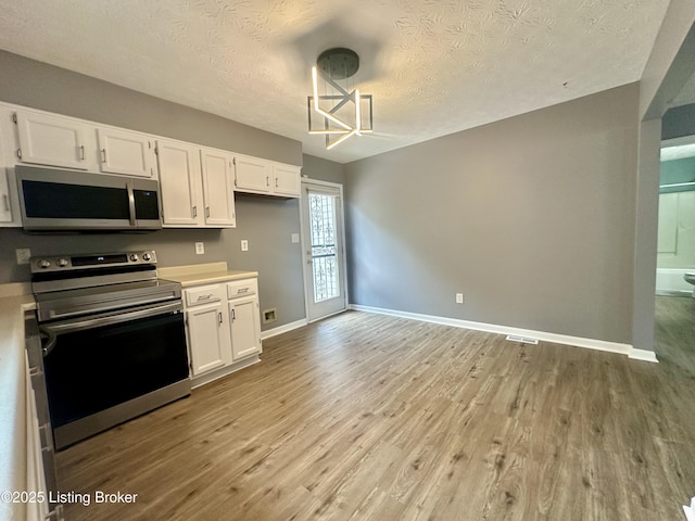 512 Auburn Oaks Dr, Louisville, KY 40214 - kitchen with stainless steel appliances, light countertops, light wood-style flooring, and a textured ceiling