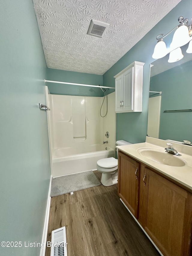 512 Auburn Oaks Dr, Louisville, KY 40214 - bathroom with wood finished floors, vanity, toilet, bathing tub / shower combination, and a textured ceiling