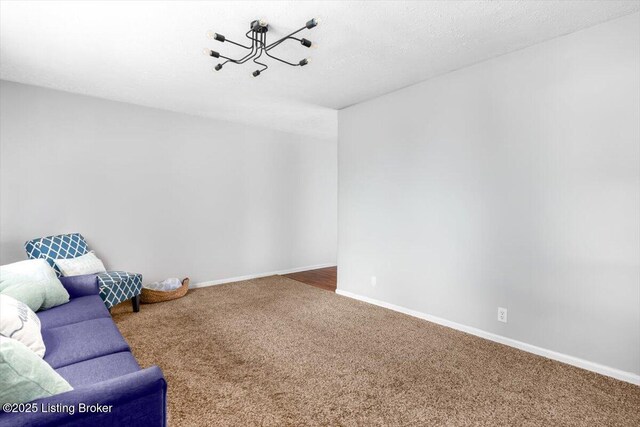 4311 Wendy Hills Dr, Crestwood, KY 40014 - unfurnished living room with carpet floors, baseboards, and a chandelier