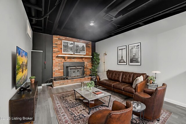 404 Bellemeade St, Brandenburg, KY 40108 - living room featuring wood finished floors, baseboards, and a fireplace