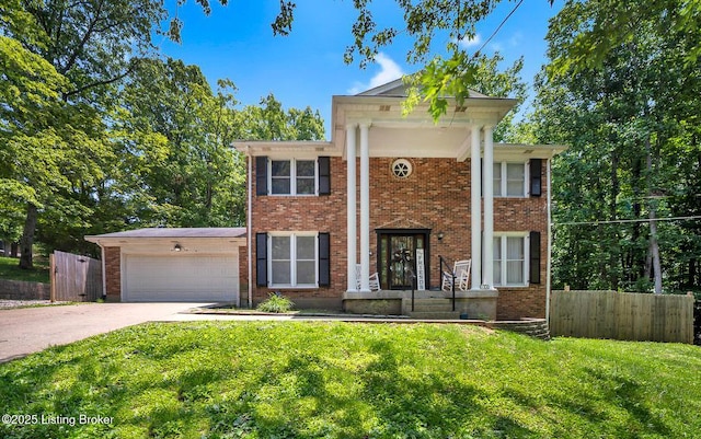 404 Bellemeade St, Brandenburg, KY 40108 - neoclassical / greek revival house featuring a garage, concrete driveway, and brick siding